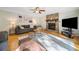 Comfortable living room with a stone fireplace, hardwood floors, and stylish furniture at 162 Nouveau Sw Ct, Lilburn, GA 30047