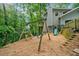 Backyard with a playset and lush landscaping, perfect for outdoor enjoyment and Gathering fun at 162 Nouveau Sw Ct, Lilburn, GA 30047