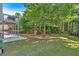 Spacious backyard with a playground, fence, and mature trees, perfect for outdoor activities at 290 Prescott Dr, Acworth, GA 30101