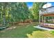 A large backyard includes a wooden playground, patio furniture, and privacy fence at 290 Prescott Dr, Acworth, GA 30101