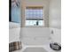 Cozy tub space featuring a soaking tub with decorative tile and a large window at 290 Prescott Dr, Acworth, GA 30101