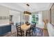 Bright dining room with a white table, black chairs, stylish light fixture, and views of the landscaped backyard at 290 Prescott Dr, Acworth, GA 30101