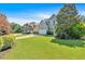 Beautiful suburban home featuring a spacious yard, two-car garage, and classic architectural details under a clear blue sky at 290 Prescott Dr, Acworth, GA 30101