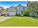 Lovely two-story home with a lush green lawn, attached garage, and inviting front entrance under a sunny sky at 290 Prescott Dr, Acworth, GA 30101
