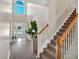 Grand foyer featuring soaring ceilings, a staircase, and a glass-paned doorway, creating a welcoming entry at 290 Prescott Dr, Acworth, GA 30101