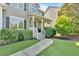 Charming front porch with stone accents, decorative columns, and a cozy seating area with manicured landscaping at 290 Prescott Dr, Acworth, GA 30101