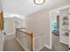 Hallway featuring natural light from a window and wooden railing with gate at 290 Prescott Dr, Acworth, GA 30101