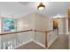 Hallway featuring natural light from a window and wooden railing at 290 Prescott Dr, Acworth, GA 30101