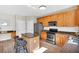 Well-lit kitchen with granite counters, stainless steel appliances, and wood cabinets at 290 Prescott Dr, Acworth, GA 30101