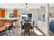 Open kitchen and dining area with hardwood floors, natural light, wooden cabinets, and modern appliances at 290 Prescott Dr, Acworth, GA 30101