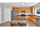 Bright kitchen features stainless steel appliances, granite countertops, and wooden cabinets at 290 Prescott Dr, Acworth, GA 30101