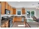 Stylish kitchen featuring stainless steel appliances, granite countertops, and wood cabinetry at 290 Prescott Dr, Acworth, GA 30101