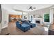 Open-concept living room with a blue sectional sofa, fireplace, and seamless flow into the adjacent kitchen at 290 Prescott Dr, Acworth, GA 30101