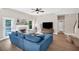 Cozy living room with a blue sectional sofa, fireplace, tray ceilings, and plenty of natural light at 290 Prescott Dr, Acworth, GA 30101