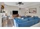 Comfortable living room featuring a fireplace, blue sectional sofa, and ample natural light at 290 Prescott Dr, Acworth, GA 30101