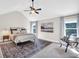 Spacious main bedroom features a tray ceiling, a ceiling fan, and large windows at 290 Prescott Dr, Acworth, GA 30101