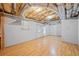 Unfinished basement with exposed ductwork and wood flooring at 412 Gray Fox Dr, Canton, GA 30114