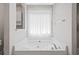 Bright bathroom with a large soaking tub and tiled surround at 412 Gray Fox Dr, Canton, GA 30114