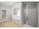 Bathroom featuring a soaking tub with shower and frosted glass door at 412 Gray Fox Dr, Canton, GA 30114