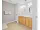 Bathroom featuring a double vanity with wooden cabinets and oval mirrors at 412 Gray Fox Dr, Canton, GA 30114