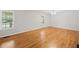 Spacious bedroom with hardwood floors and natural light from two large windows at 412 Gray Fox Dr, Canton, GA 30114