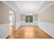 Bright dining room featuring hardwood floors, wainscoting, and a modern chandelier at 412 Gray Fox Dr, Canton, GA 30114