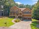 Charming two-story home with a welcoming front porch and well-manicured lawn at 412 Gray Fox Dr, Canton, GA 30114