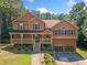 Traditional two-story home featuring a covered porch and attached two-car garage at 412 Gray Fox Dr, Canton, GA 30114