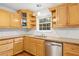 Well-lit kitchen featuring wood cabinetry, stainless steel appliances, and durable countertop for easy cooking at 412 Gray Fox Dr, Canton, GA 30114