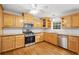 Charming kitchen with natural wood cabinets, stainless steel appliances, and warm hardwood flooring at 412 Gray Fox Dr, Canton, GA 30114