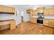 Well-equipped kitchen featuring wood cabinets, stainless steel appliances, and built-in desk area at 412 Gray Fox Dr, Canton, GA 30114