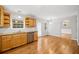 Inviting kitchen with wood cabinets, stainless steel dishwasher, and hardwood floors flows into dining area at 412 Gray Fox Dr, Canton, GA 30114