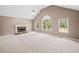 Bright living room with vaulted ceilings, a charming fireplace, and large windows offering ample natural light at 412 Gray Fox Dr, Canton, GA 30114