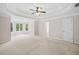 Large main bedroom featuring tray ceilings, plush carpeting, and natural light at 412 Gray Fox Dr, Canton, GA 30114