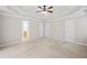 A spacious main bedroom featuring a tray ceiling and plush carpet at 412 Gray Fox Dr, Canton, GA 30114