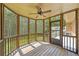 Cozy screened-in porch with wooden floors and a ceiling fan, perfect for relaxation at 412 Gray Fox Dr, Canton, GA 30114