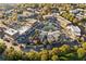 Aerial view of a vibrant shopping center with various storefronts, parking lots, and lush greenery at 6455 Darely Ct, Cumming, GA 30040