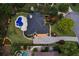 Aerial view of a home with a backyard pool, lush landscaping, and extended driveway at 6455 Darely Ct, Cumming, GA 30040