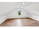 Spacious attic featuring wood floors, natural light, and neutral walls at 6455 Darely Ct, Cumming, GA 30040