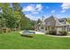 Expansive backyard features lush landscaping, a kidney-shaped pool, a spa, and meticulous landscaping at 6455 Darely Ct, Cumming, GA 30040