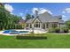 Stunning backyard with a large in-ground pool, spa, lush lawn, and beautiful landscaping at 6455 Darely Ct, Cumming, GA 30040