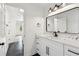 Bright bathroom with a large mirror, white marble countertops, and black fixtures at 6455 Darely Ct, Cumming, GA 30040