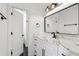 Bathroom with a marble countertop, large mirror, and black hardware at 6455 Darely Ct, Cumming, GA 30040