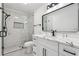 Modern bathroom featuring a marble countertop, vanity, and a glass-enclosed shower at 6455 Darely Ct, Cumming, GA 30040