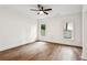 Bright bedroom offering hardwood floors and two windows showcasing the outside scenery at 6455 Darely Ct, Cumming, GA 30040