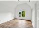 Inviting room with vaulted ceiling, wood floors, and scenic view of the outdoors at 6455 Darely Ct, Cumming, GA 30040