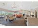 Open dining area with modern lighting, carpet, large windows, tables, and comfortable seating at 6455 Darely Ct, Cumming, GA 30040