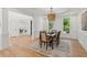 Bright dining room with wainscoting, hardwood floors, and a view to the entryway at 6455 Darely Ct, Cumming, GA 30040