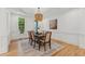 Elegant dining room featuring wainscoting, hardwood floors, and a decorative chandelier at 6455 Darely Ct, Cumming, GA 30040