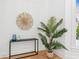 Bright entryway featuring a modern table, wall art, and a plant at 6455 Darely Ct, Cumming, GA 30040